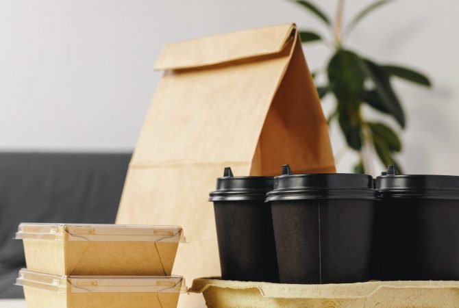 Paper bags with take away food and coffee cups containers